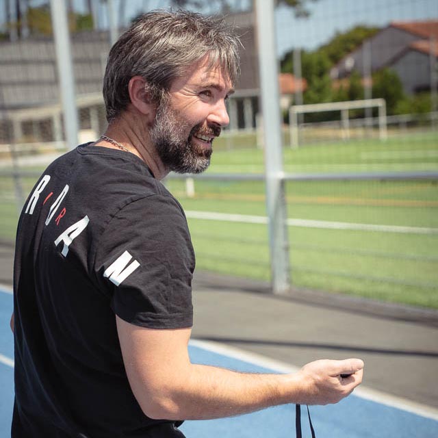 `Fabien Lageyre, diététicien-nutritionniste et coach sportif à Dax et Saubrigues, sur une piste d’athlétisme avec un chronomètre`